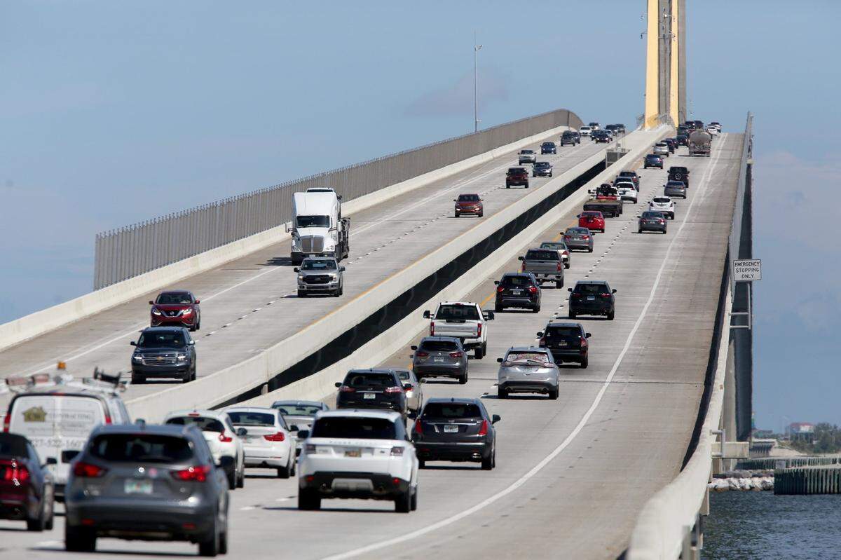 DOUGLAS R. CLIFFORD | Times Traffic streams over the Sunshine Skyway Bridge on Wednesday, July 21, 2021, in St. Petersburg, where the new suicide prevention barrier has been completed.