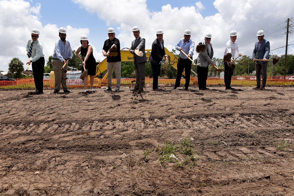 Officials throw a shovelful of dirt at the official groundbreaking Monday for The Addison, an affordable housing project in Bradenton.
