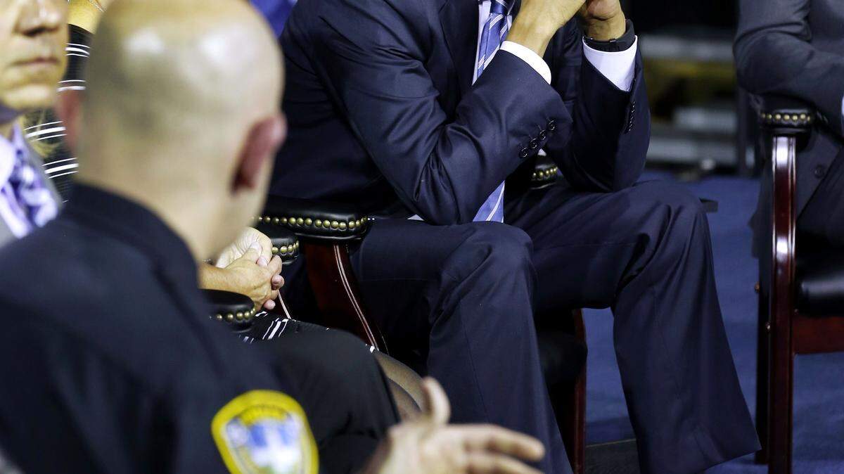 President Obama listens to speakers Wednesday during an event at the East End Family Resource Center in Charleston, W.Va. 
 STEVE HELBER/Associated Press