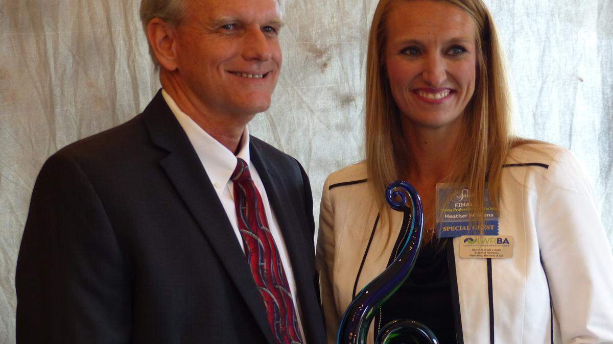 Paul Hoffman, President at SouthTech presented the Young Professional of the Year Award to Heather Williams of Kerkering, Barberio & Co. at the Lakewood Ranch Business Alliance's 2015 Sandies Awards. JANELLE O'DEA/Bradenton Herald