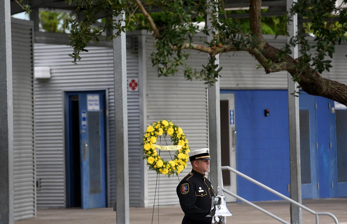 A member of the Manatee County Emergency Services color guard prepares to ring the bell at the Tribute to Heroes Memorial Service at Bradenton’s Riverwalk Tuesday morning.