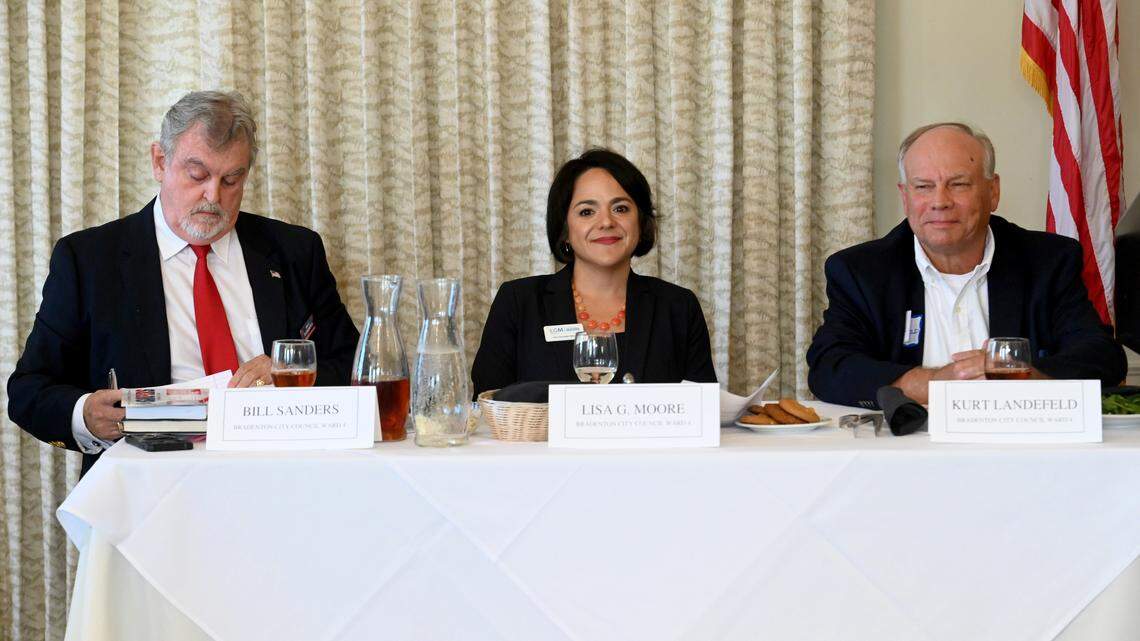 Bradenton City Council Ward 4 incumbent Bill Sanders (left) looks at his notes while he sits with challengers Lisa Gonzalez Moore (middle) and Kurt Landefeld (right) during a debate at the meeting of the Manatee Tiger Bay Club at Pier 22 Sept. 22, 2022.