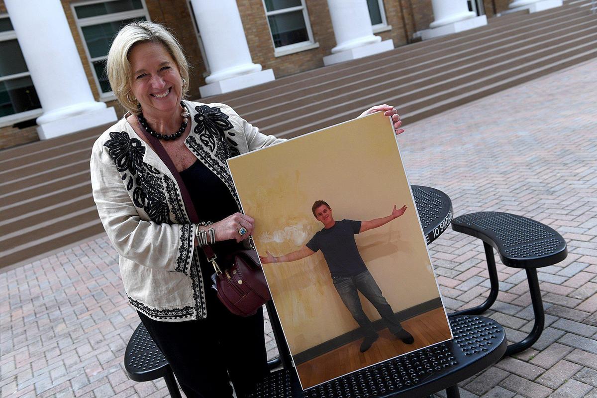 Michelle Cherp holds up a photo of her son, Alexander Cherp, after Alan Baily was sentenced to life in prison for the killing of Cherp in 2017.