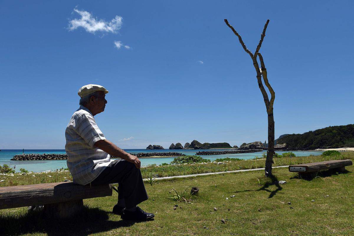 Takeichi Kakinohana, 85, lives on Aka Island where the American military landed during the Battle of Okinawa and where, eventually, the Japanese ceremonially surrendered on the beach where he sits on Aug. 1, 2015. Takeichi, conscripted by the Japanese Army at 15, hid with other islanders in the mountains for months when the Americans landed. (Tiffany Tompkins-Condie/McClatchy DC/TNS)
