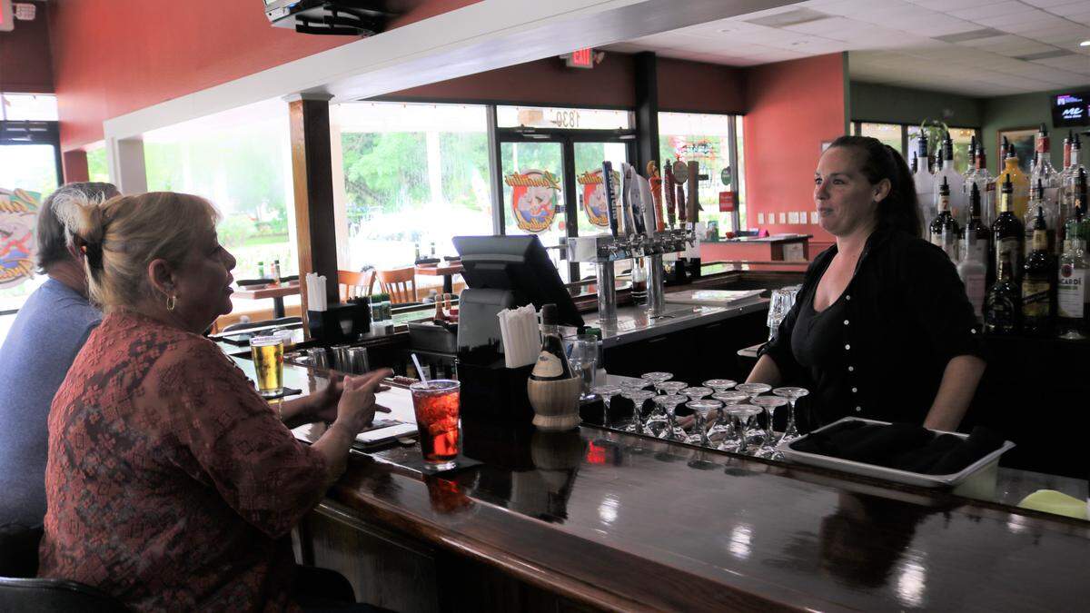 Bartender Katelyn Grant chats with Karen Kall at Lamantini Trattoria, 1830 59th St. W., Bradenton. The new restaurant opened in July.