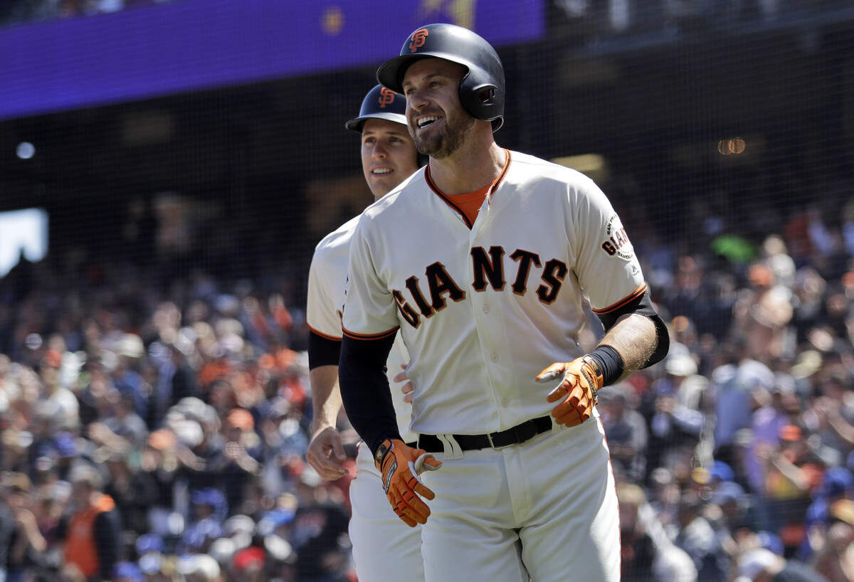 Former Tampa Bay Rays star Evan Longoria told the Tampa Bay Times he thinks the Rays should move. In this file photo, Longoria, now with the San Francisco Giants, smiles in front of teammate Buster Posey after Longoria's three-run home run during the first inning of a baseball game against the Los Angeles Dodgers Sunday, April 29, 2018, in San Francisco.