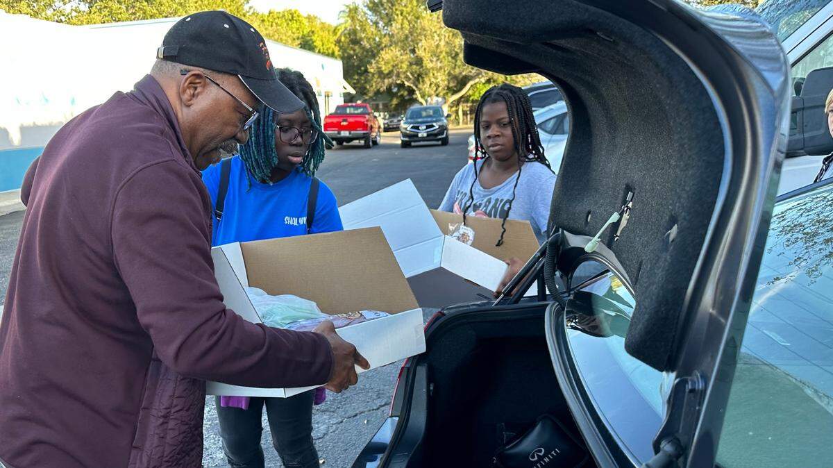 Kenneth Mays loads Thanksgiving food boxes into his car 11/21/2023 intended for members of St. John Church in Palmetto.