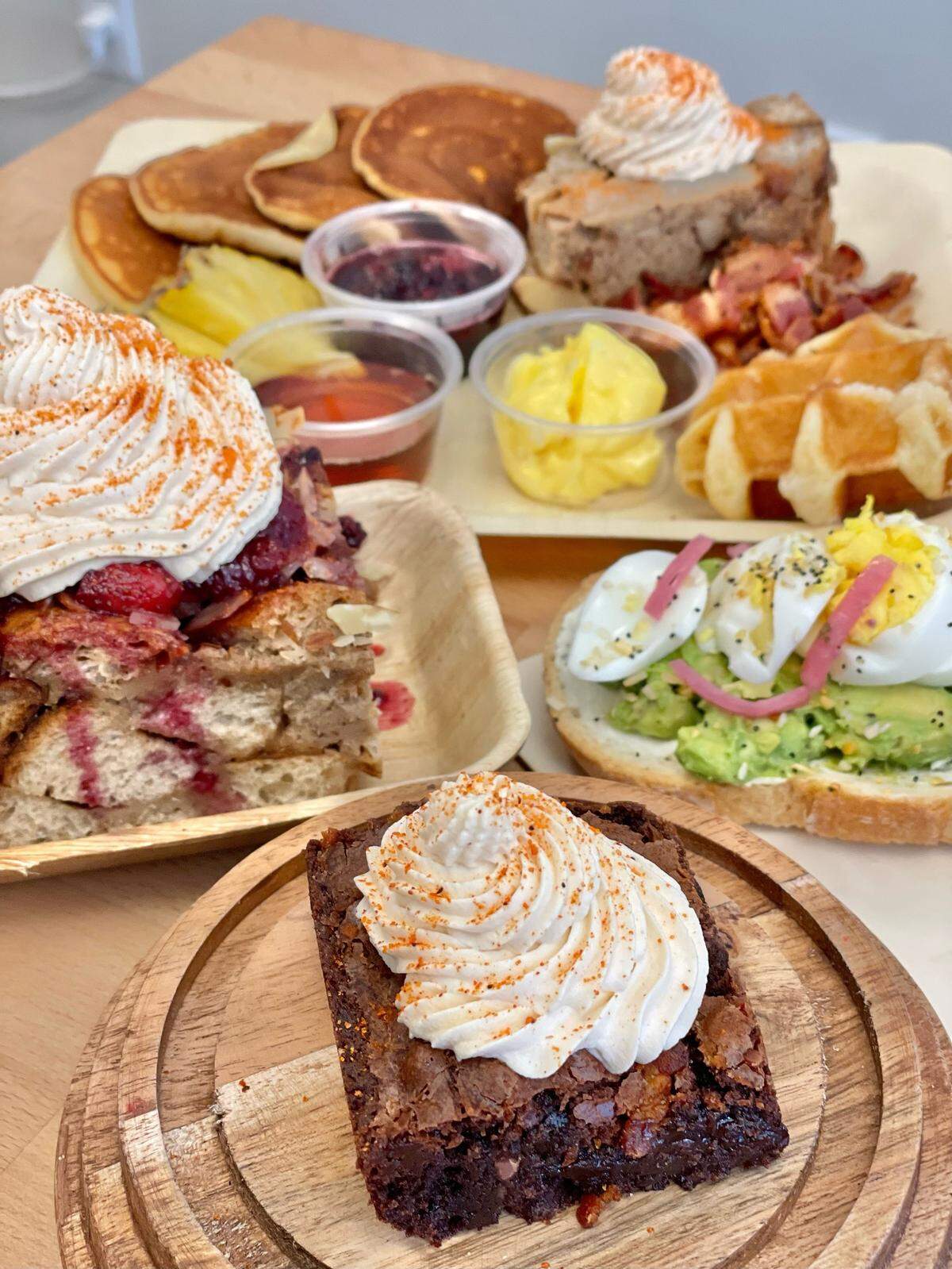 Among the featured baked goods at Graze Street AMI are almond bread pudding with a rose berry compote and maple bourbon whipped cream and Guajillo brownie with maple bourbon whipped cream.