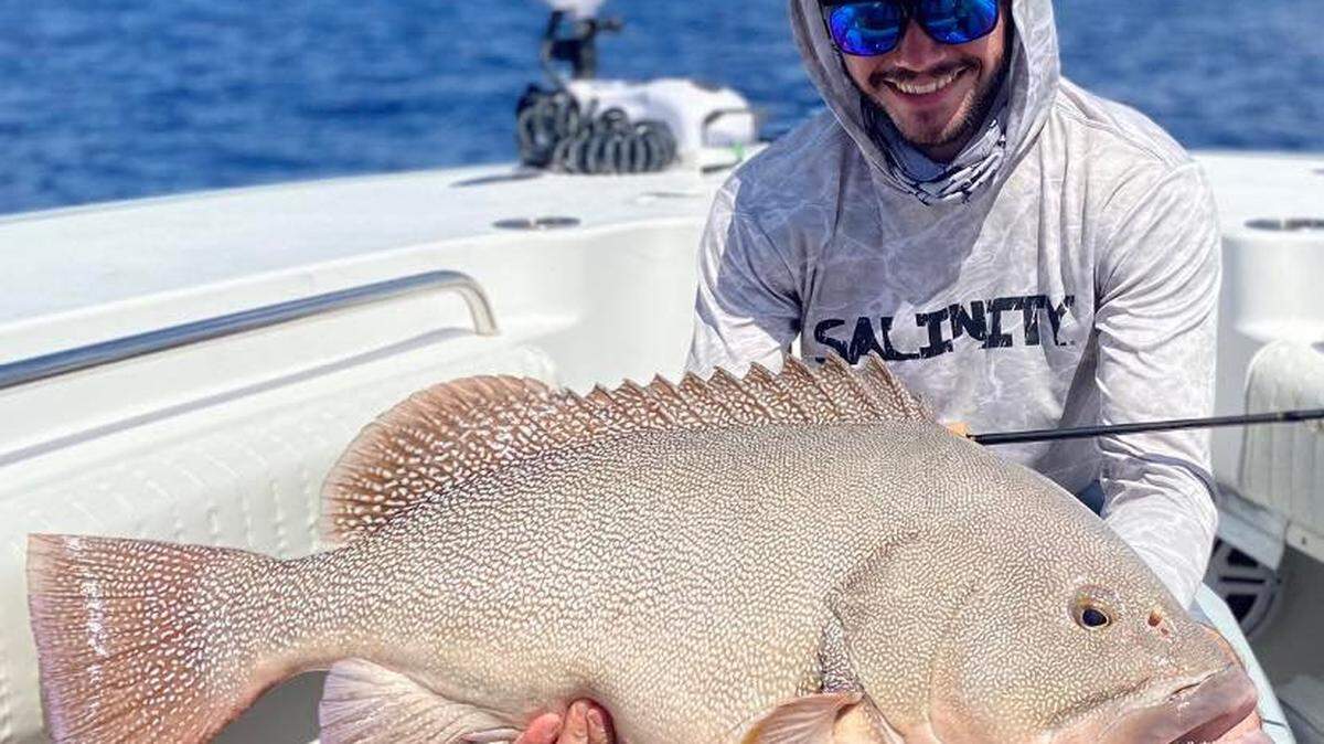 Alex Pearson shows off the Kitty Mitchell grouper he caught in 600 feet of water in April 2022.