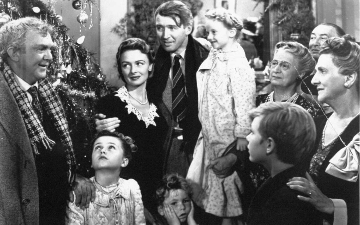FILE - In this 1946 file photo originally provided by RKO Pictures Inc., legendary actor James Stewart as George Bailey, center, is reunited with his wife played by actress Donna Reed, third from left, and family during the last scene of Frank Capra's "It's A Wonderful Life." (AP Photo/RKO Pictures Inc.)