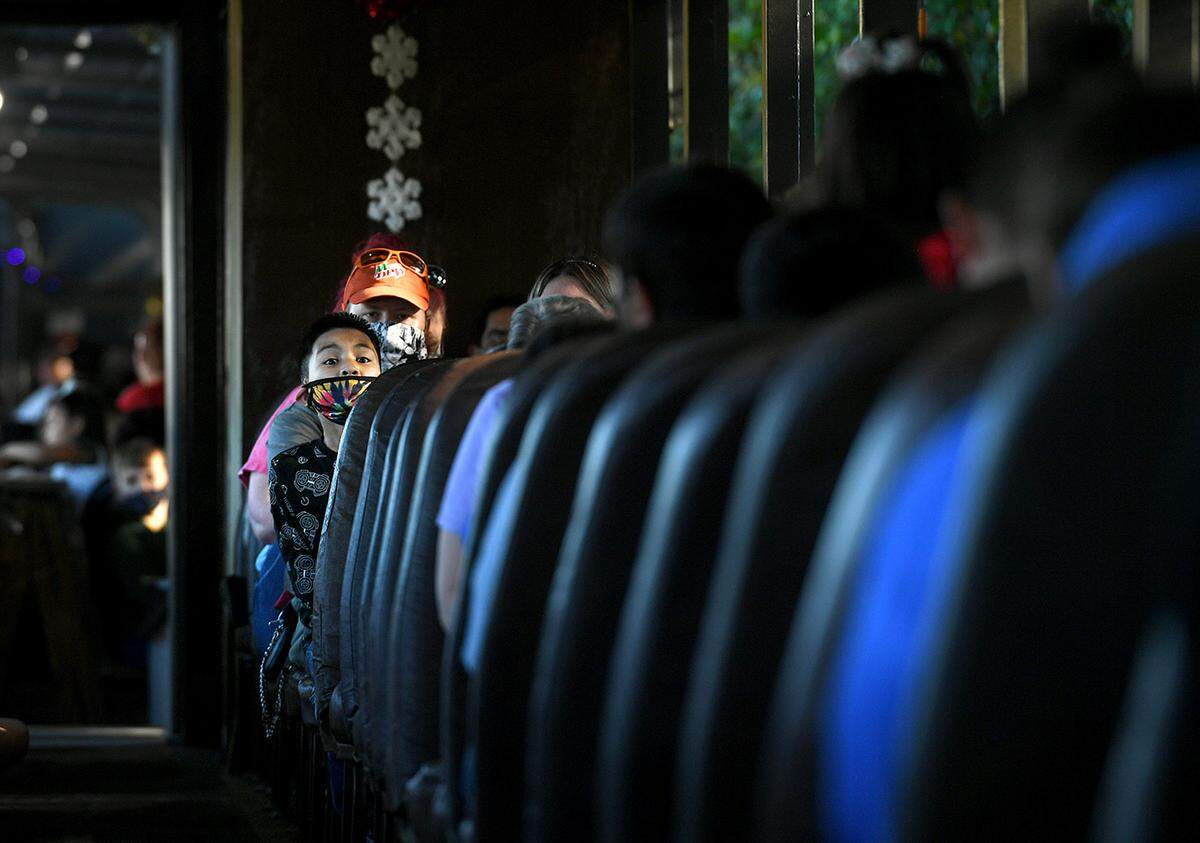 12/08/21—A child waits in excitement as children and their families boarded the North Pole Express at the Florida Railway Museum for a trip to meet Santa at the 36th annual event for terminally ill children.