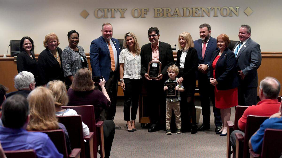 Outgoing councilman Patrick Roff stands with his family and present council members at the Bradenton City Council’s swearing in ceremony during a special session on January 3, 2023.