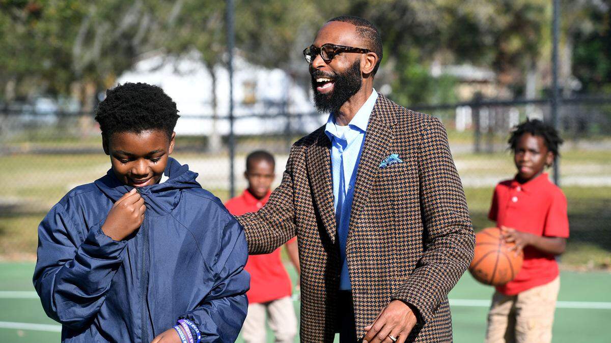 Derrick Randall, U.S. Army veteran and CEO and director of the United Community Center’s 13th Av Dream Center and the Rubonia Community Program talks with kids out on the basketball court.