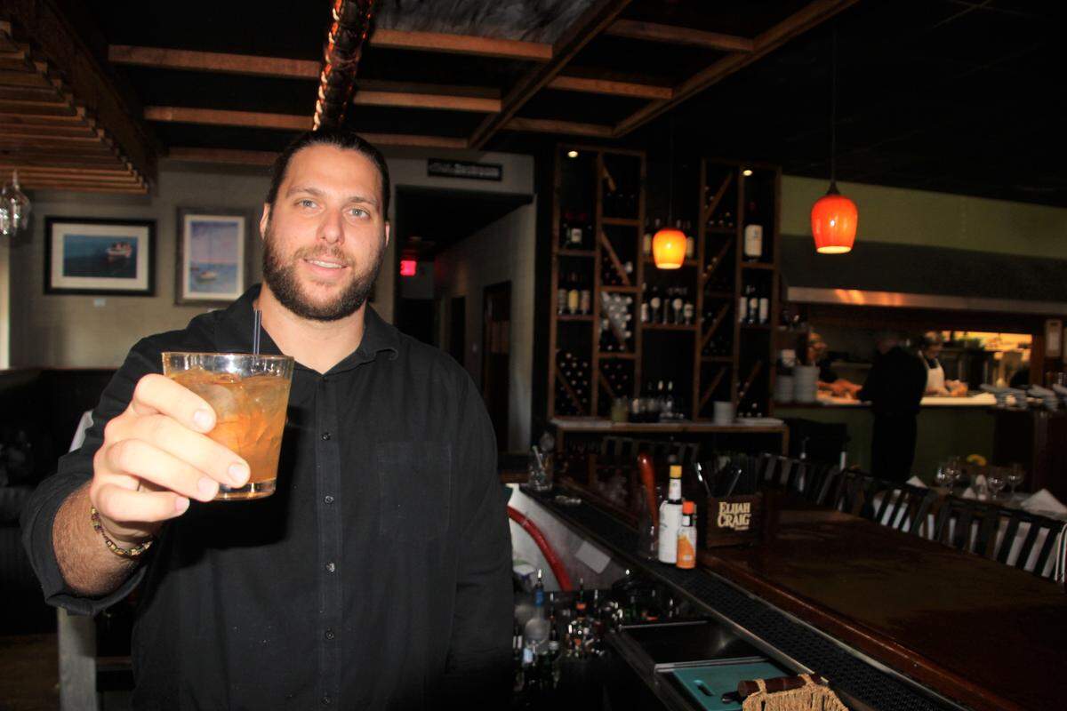 Jason Schneider offers a shrub apple pie cocktail at enRich Bistro, 5629 Manatee Ave. W., Bradenton.
