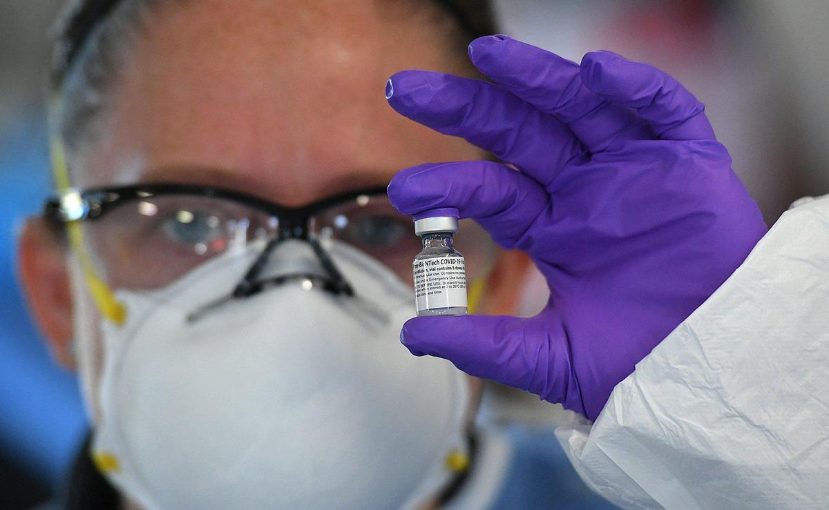 12/22/20--Manatee County EMS paramedic Beth Tucciarone holds vaccine for first responders get vaccinated for COVID-19 in a medical tent set up on the grounds of the public safety complex in Bradenton.