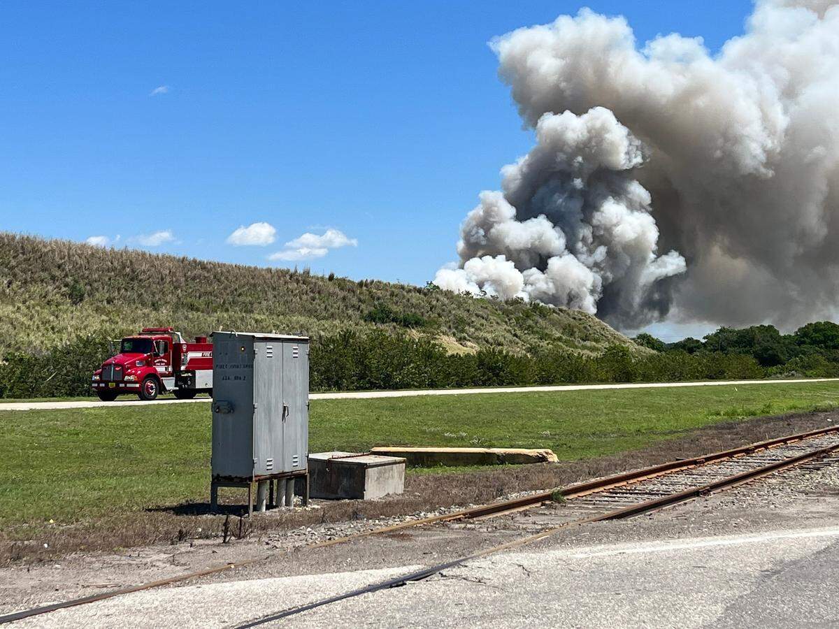 A North River fire truck drives back and forth from the scene of a scrapyard fire on Saturday, April 9, 2021.