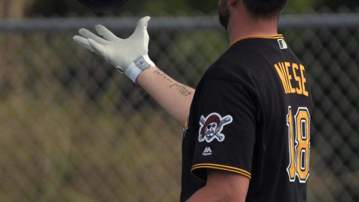 Pittsburgh Pirates pitcher Jonathan Niese flips is batting helmet into the air during spring training workouts Monday at Pirate City in Bradenton. 
 GRANT JEFFERIES/Bradenton Herald