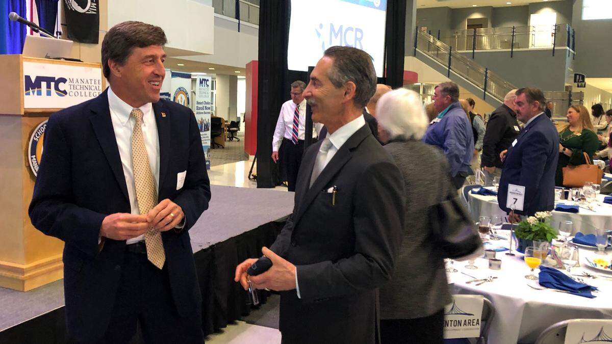 1/24/2020--Kevin DiLallo, CEO of Manatee Healthcare System, left, talked to economist Hank Fishkind on Jan. 24, 2020, at Manatee Technical College after Fishkind’s economic forecast to the Bradenton Area Economic Development Corp. This year, because of COVID-19, Fishkind presented his forecast on Zoom.