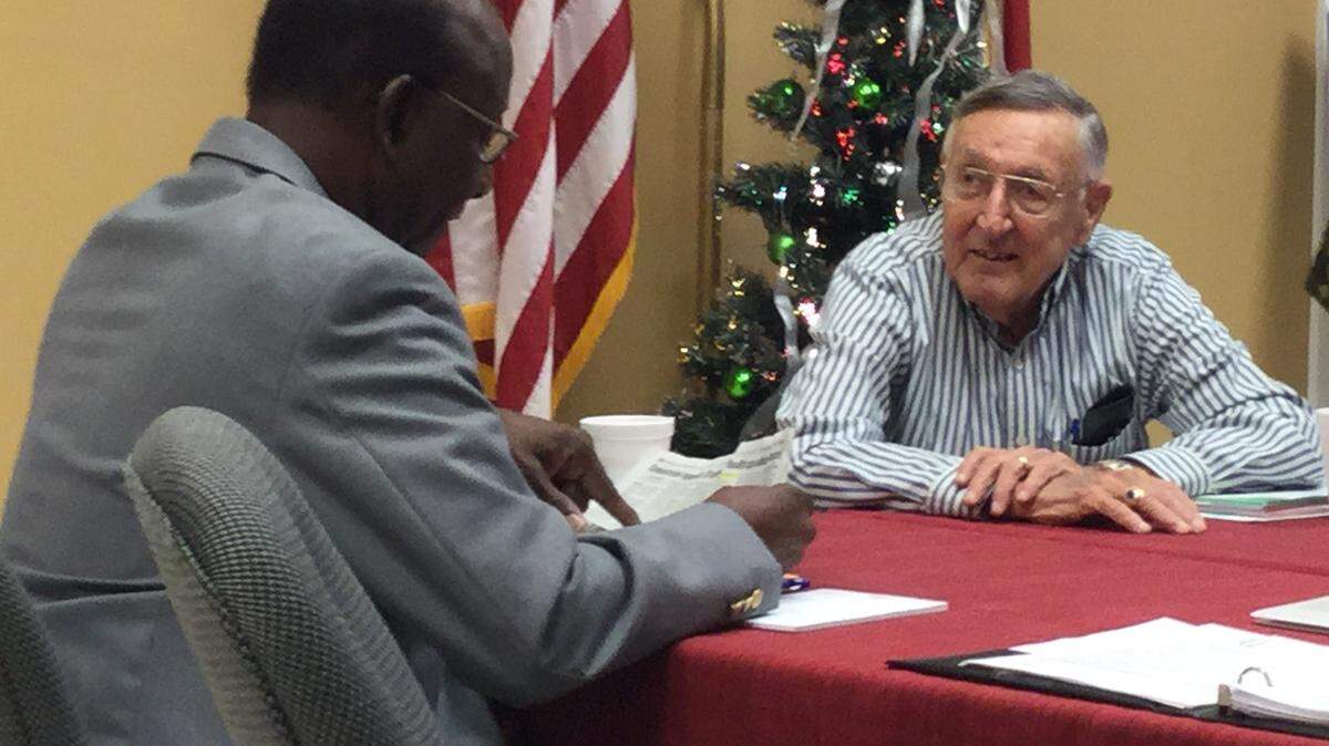Bradenton Housing Authority board Chairman Napoleon Mills talks with Commissioner Charlie Grace prior to Grace's final meeting on Thursday. He will be resigning from the all-volunteer board after six years. MARK YOUNG/Bradenton Herald