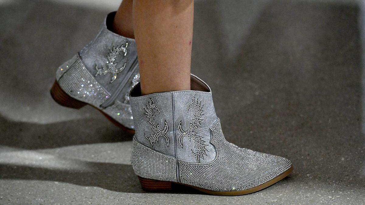 Manatee Mini Fair Queen Gracyn Carpenter, 8, wears glittery boots with her dress at the luncheon for the Manatee County Fair’s distinguished citizens on Jan. 5, 2023.
