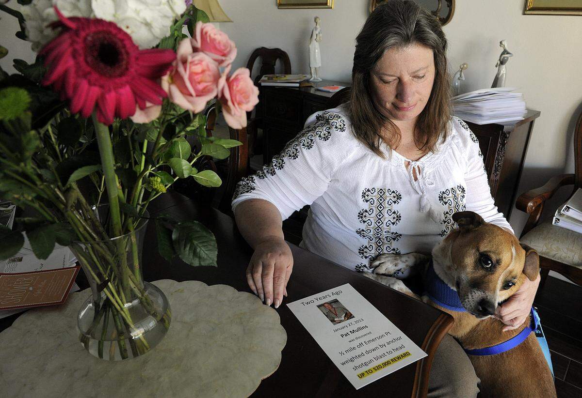 Jill Mullins, wife of Palmetto High School media specialist Pat, who disappeared on Jan. 27, 2013 and found dead Feb. 7, 2013, handed out flyers at Emerson Point and to boaters at local boat ramps. Beagle mix Cole is one of her two dogs.