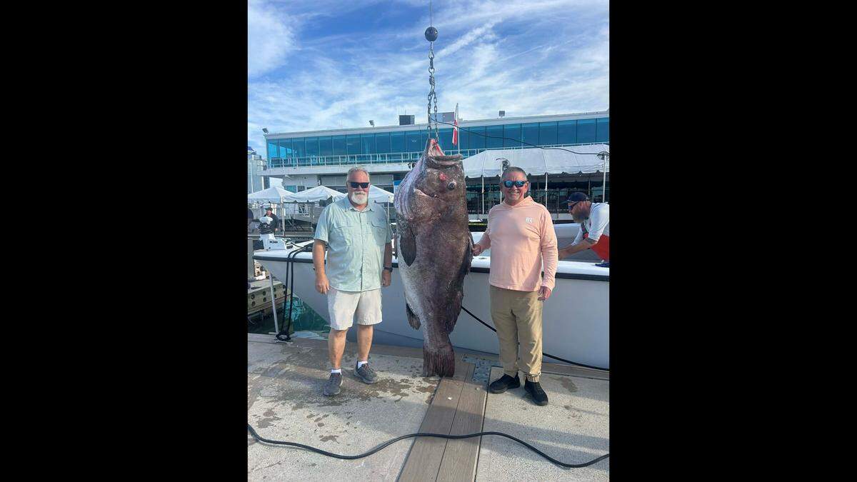 Anglers pose with the massive Warsaw grouper caught while with captain Dion Davis in 500 feet of water.