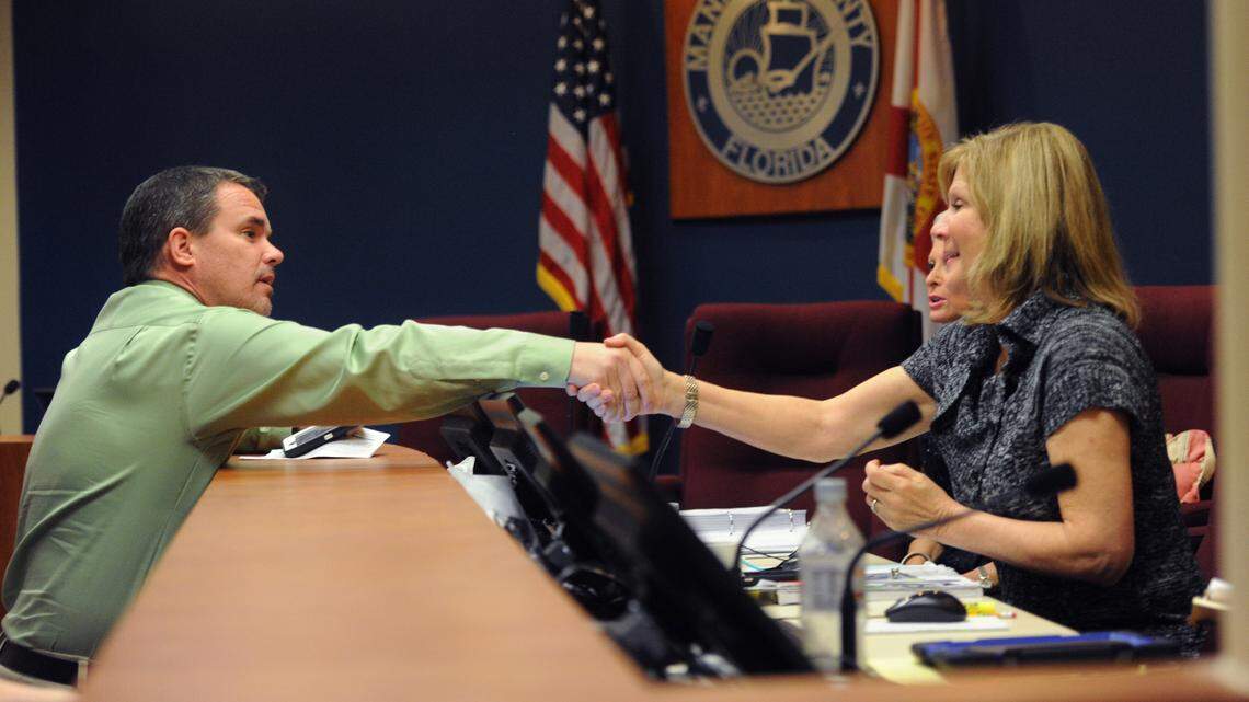 Charlie Kennedy, Manatee County School Board, shakes hands with commissioners Robin DiSabatino and Carol Whitmore, after a vote by the commission to support a recommendation by the school board to reinstate impact fees to pay for schools in January 2016. 
 GRANT JEFFERIES/Bradenton Herald
