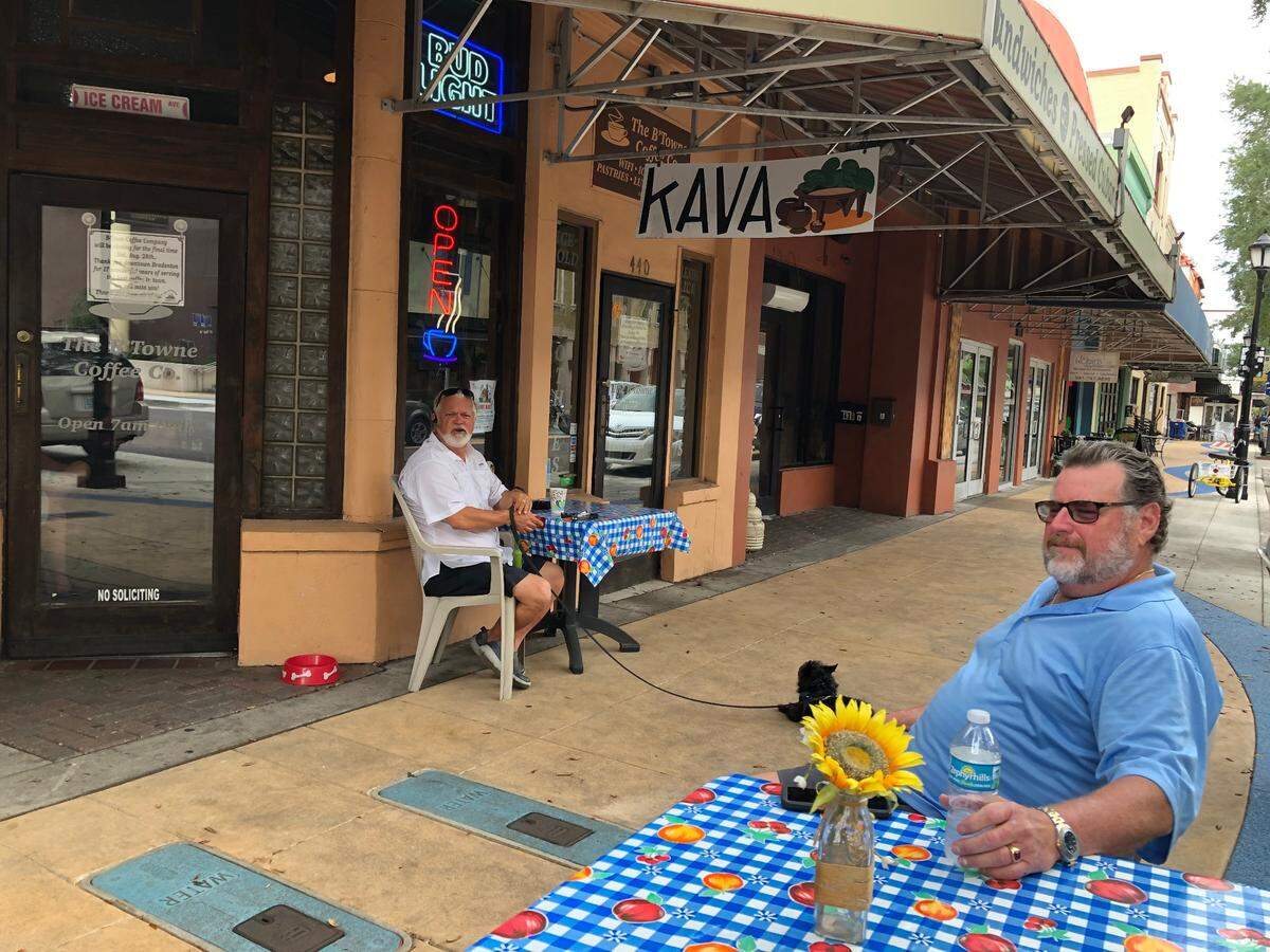 08/24/2021--After 17 years of serving specialty coffees, pastries and sandwiches, on Bradenton’s Old Main Street, The B’Towne Coffee Co., is closing its doors for good on Saturday. Aug. 28 . Partner Greg “Smitty” Smith is shown above at a sidewalk table in the blue shirt.