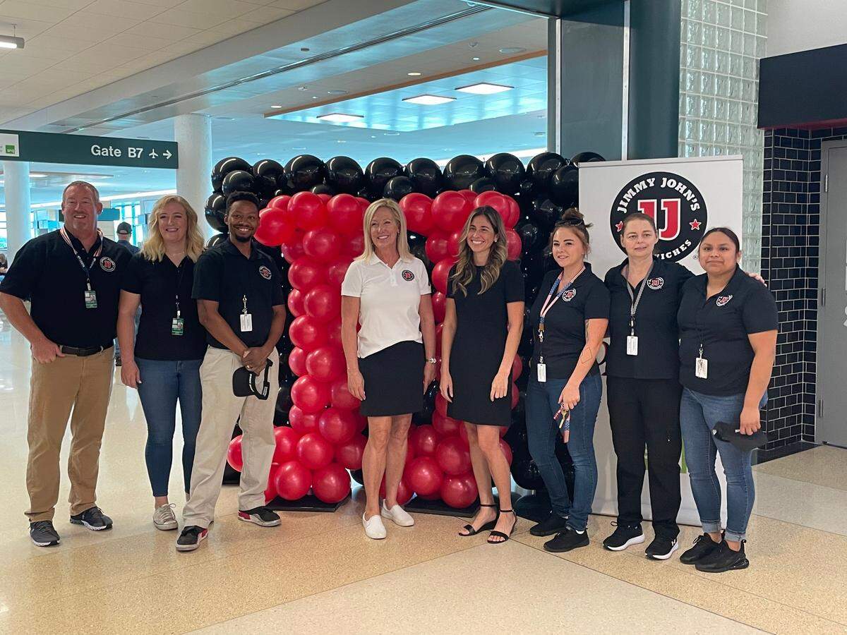 Mark Mitchell, far left, owner of Jimmy Johns, and his staff are shown in front of the restaurant’s new location within the Sarasota Bradenton International Airport.