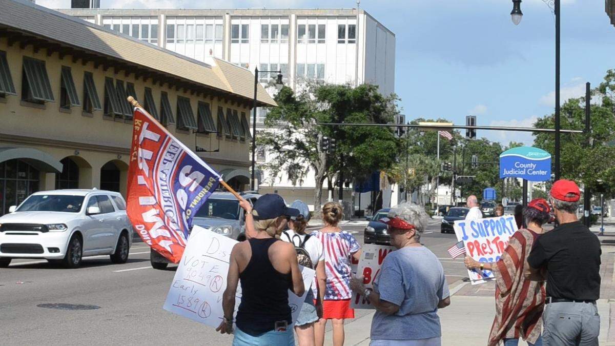 Supporters of President Donald Trump waved signs and flags outside of Representative Vern Buchanan’s Bradenton office on May 20, 2019.