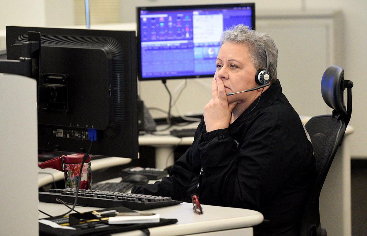 911 operator Lisa Kalmbach takes a call in the Public Safety Center in Bradenton. For the first time, Florida is activating protocols for enhanced screening of 911 calls in order to determine if first responders could be walking into situation with a potential case of the novel coronavirus, known as COVID-19.