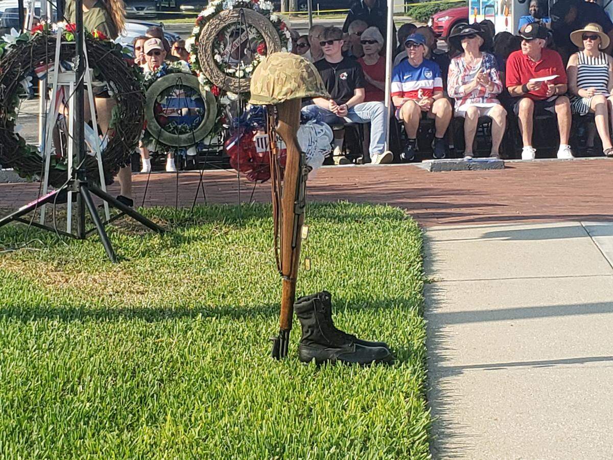 A battlefield cross sits before the monument at Veteran’s Monument Park in Bradenton during the annual Memorial Day service.