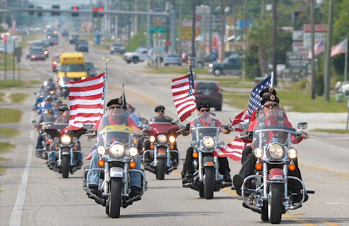 Dozens of American Legion Riders ride along 15th St. E. while under police escort as they head to Manasota Memorial Park for a pre-Memorial Day service in East Bradenton on Saturday, May 24, 2014.