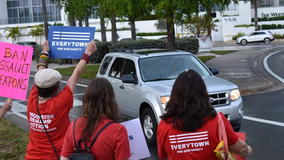 Before marching across the John Ringling Causeway for the Sarasota March For Our Lives, protesters held signs up for passing cars at the Sarasota Bayfront Park on Saturday morning.