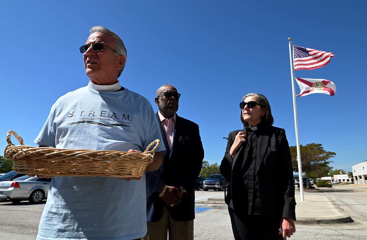 Fr. Glen Graczyk of St. Mary’s Episcopal Church in Palmetto with Ossie Reid of Harvest United Methodist Church and Rev. Kim Uchimura, Sr. Pastor at Emmanuel United Methodist Church deliver hundreds of letters in support of a pre-arrest diversion program to Manatee County Sheriff Rick Wells.