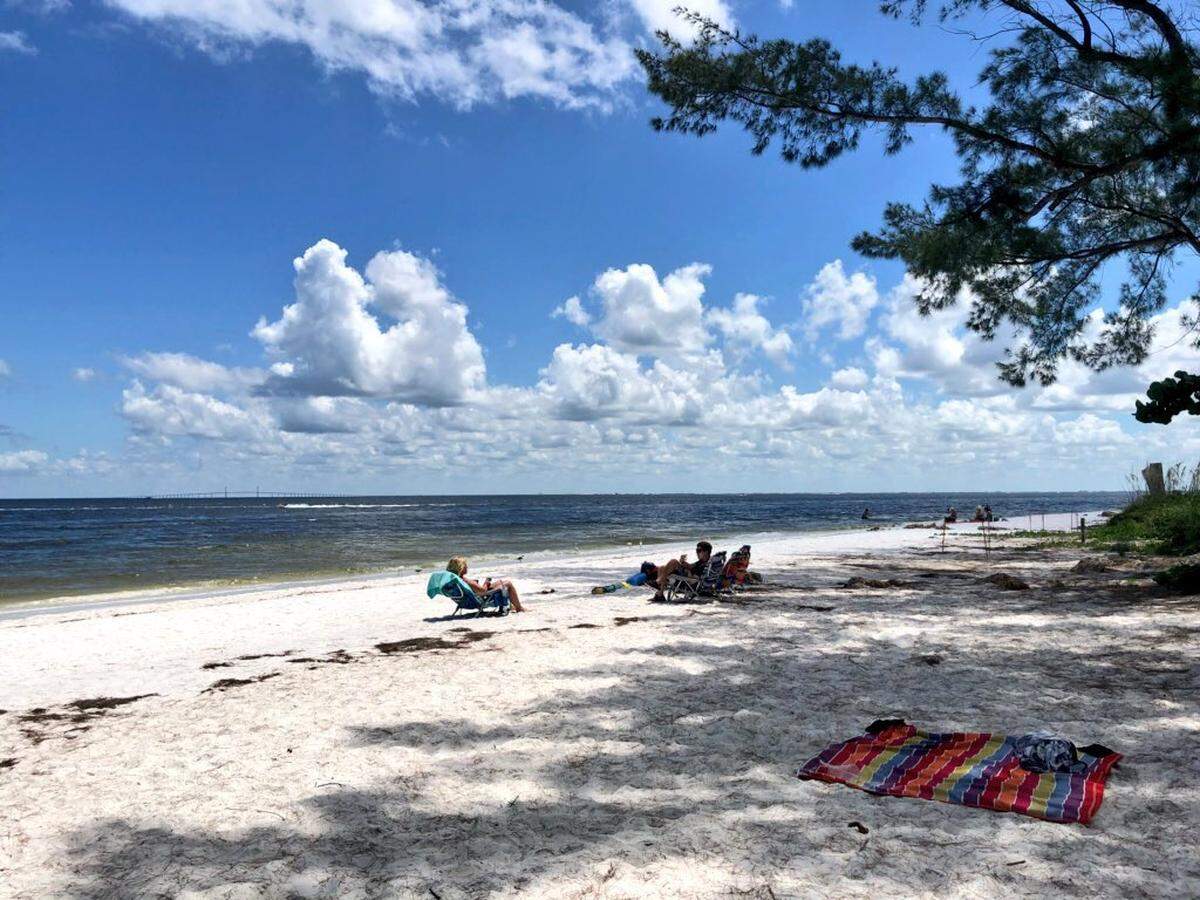 While beachgoers on Anna Maria Island, near Bean Point, enjoyed the sun and water on Sunday afternoon most were wary of red tide looming just a couple of miles south.