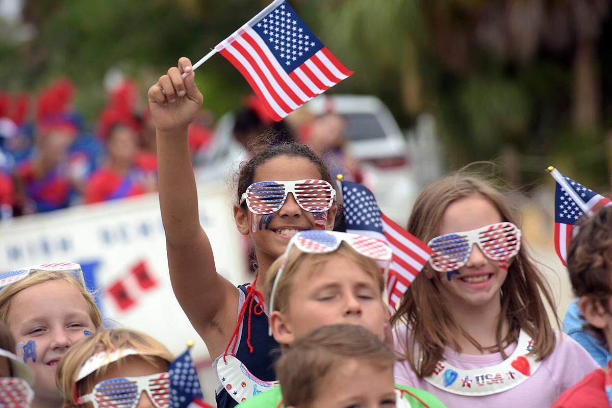 Children from The Center of Anna Maria wave flags during Anna Maria Island’s “Old Soldiers and Sailors” parade to honor Veterans. The island event returns Monday, Nov. 12.