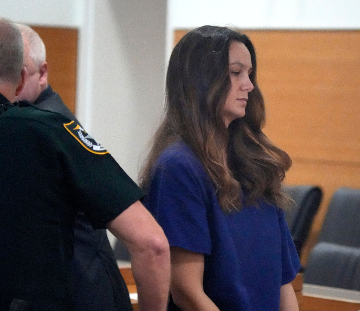 Ashley Benefield led away in handcuffs in a Manatee County courtroom after Judge Matt Whyte sentenced her to 20 years in prison for manslaughter in the 2020 shooting death of her husband.