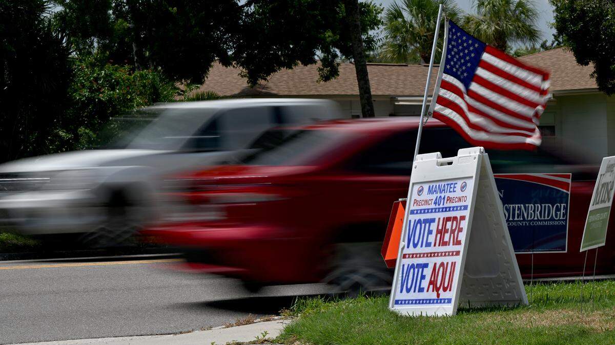 Cars whiz past Bayside Church on 26th Street where voting was underway in the primary election.