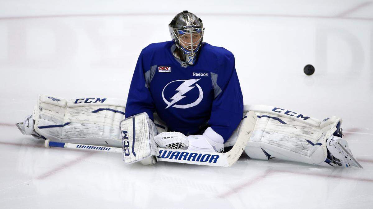 Tampa Bay Lightning goalie Kristers Gudlevskis stretches during hockey practice at the Consol Energy Center in Pittsburgh, Sunday May 15, 2016. The Lightning were preparing for Game 2 of the Eastern Conference Finals against the Pittsburgh Penguins on Monday in Pittsburgh. (AP Photo/Gene J. Puskar)