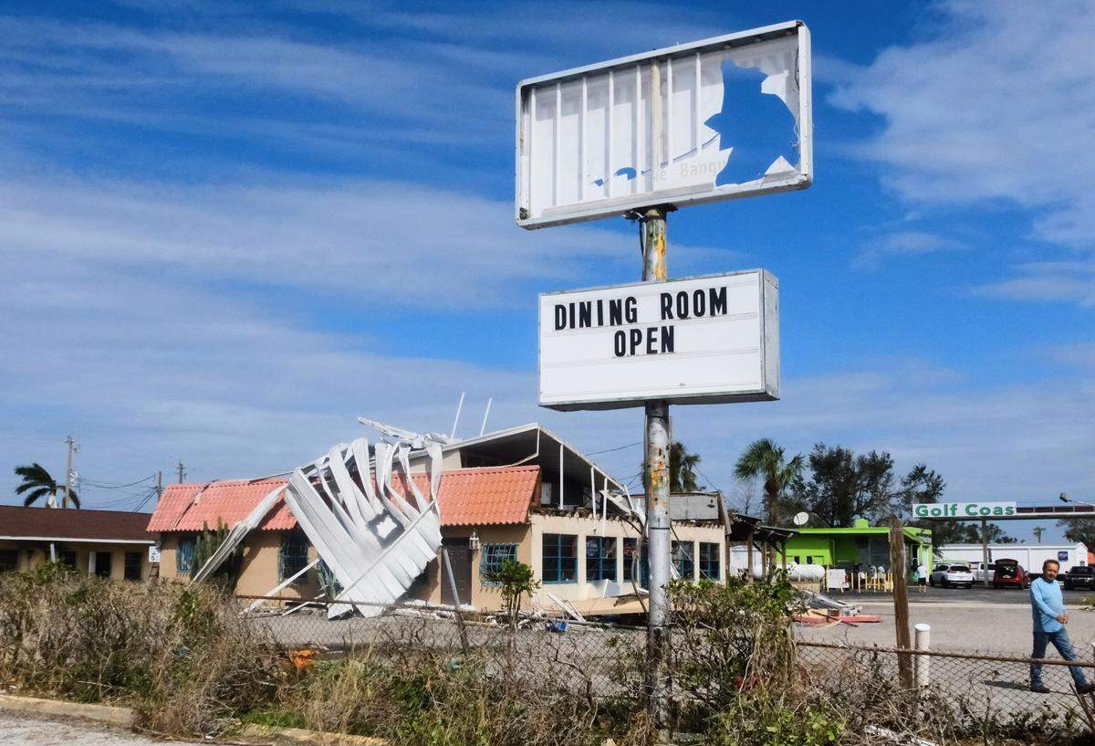 After Hurricane Milton, the battered sign of King Buffet Chinese Restaurant in Palmetto stands in front of the neighboring Alvarez Mexican Restaurant, which had part of its roof ripped off. Friday, Oct. 11, 2024.