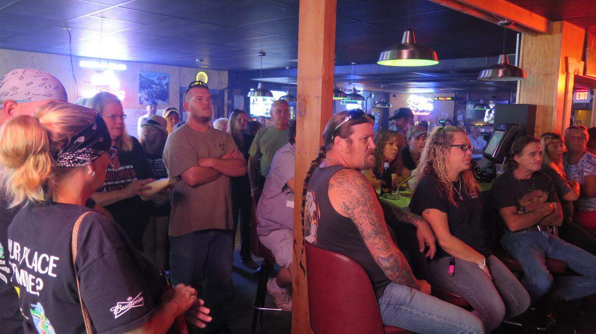 Bar patrons, fellow bar owners and bartenders listen to a speaker Monday evening at a rally held inside the Dolphin Lounge in Bradenton. The rally aimed to take a stand against the recent string of bar robberies in Manatee County. 
 AMARIS CASTILLO/Bradenton Herald