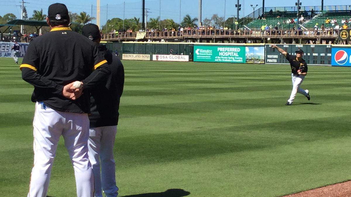 Pitchers for the Pittsburgh Pirates warm up under the watchful eye of coaches before their opening game against the Minnesota Twins on Saturday to kick off the 2020 MLB spring training games.