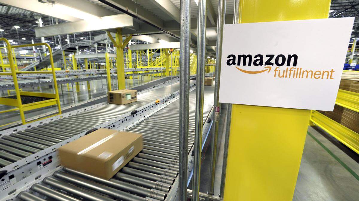 FILE - In this Feb. 13, 2015, file photo, a package moves along a conveyer belt during a media tour of the Amazon.com fulfillment center in DuPont, Wash. Amazon.com reports quarterly financial results Thursday, Jan. 28, 2016. (AP Photo/Ted S. Warren, File)
