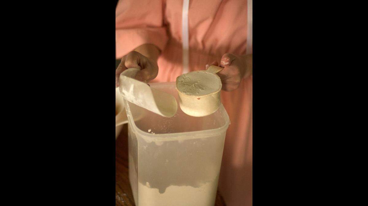 Lovina’s daughters have pitched in to do most of the cooking while she recuperates from surgery. Here one daughter measures out flour for a batch of cookies.