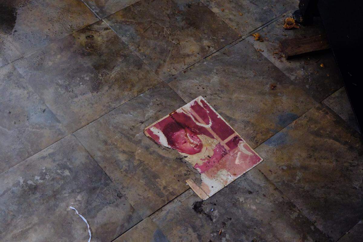 A damaged family photo lies on the floor of Howard Brooks’ home in Rubonia after it was ravaged by flood waters during Hurricane Helene.