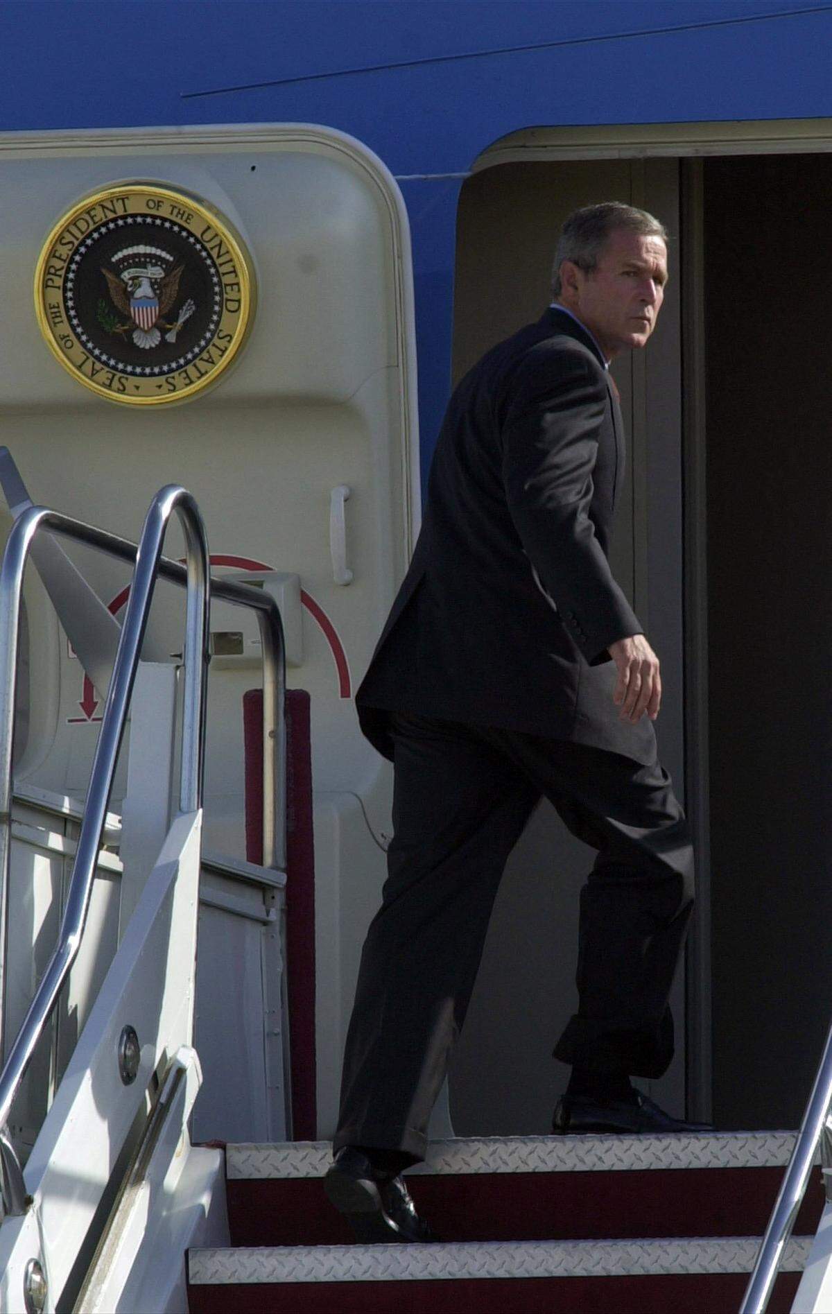 A grim President George W. Bush enters Air Force One at Sarasota-Bradenton International Airport, September 11, 2001, after terrorist attacks in New York and Washington.