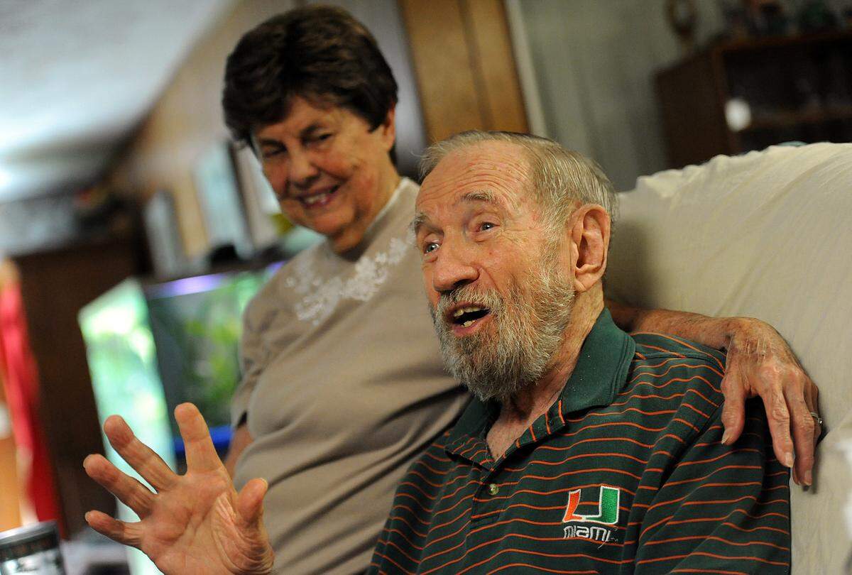 10/3/2014--Ed Dick tells one of his many, many stories, with wife, Joanne, in their Bradenton home.