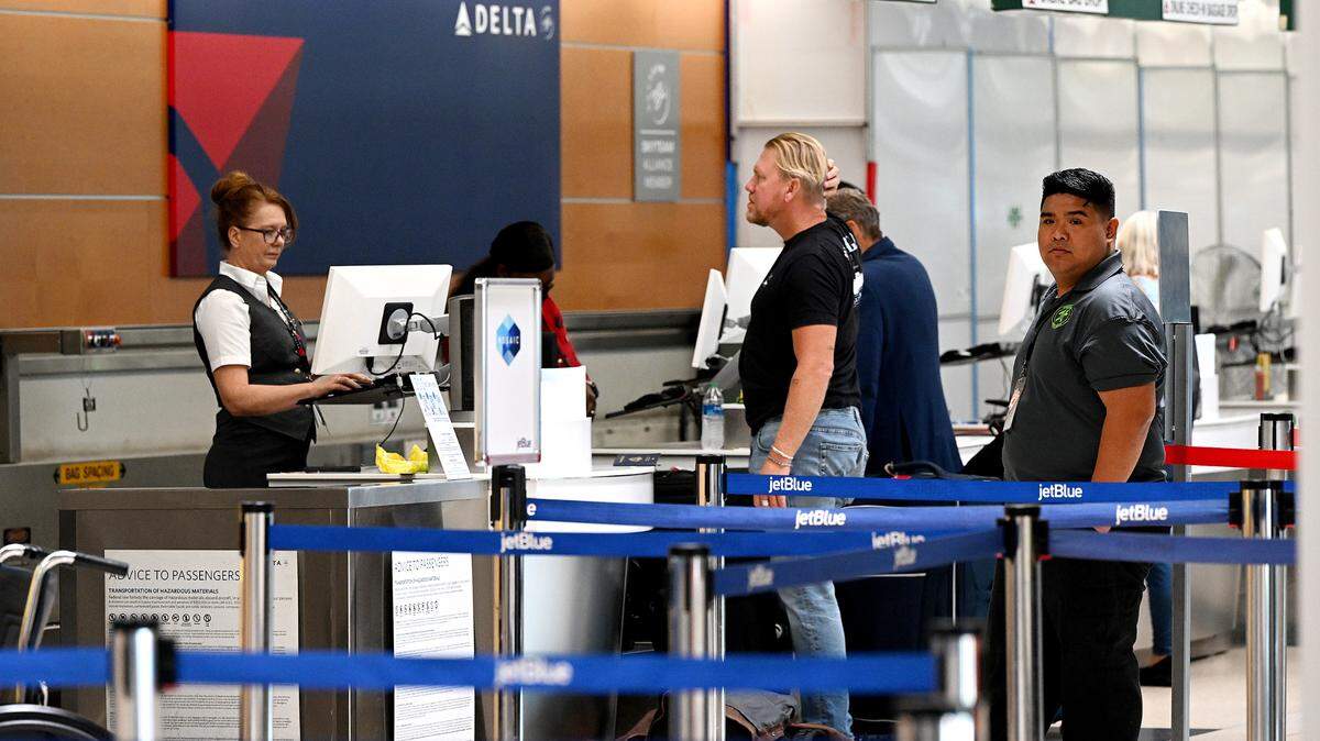 Travelers wait at the Delta ticketing desk at the Sarasota Bradenton International Airport on Sept. 25, 2023. The airport is now expected to remain closed until Oct. 16, 2024, after Hurricane Milton.