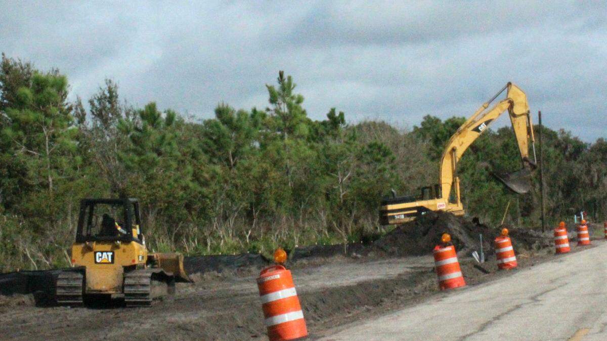 Heavy machinery works on the shoulder of Fort Hamer Road cleared of trees and brush. 
 JAMES A. JONES JR./Bradenton Herald